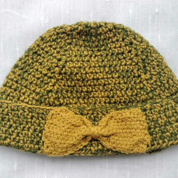 Hand-knitted yellow hat and cowl