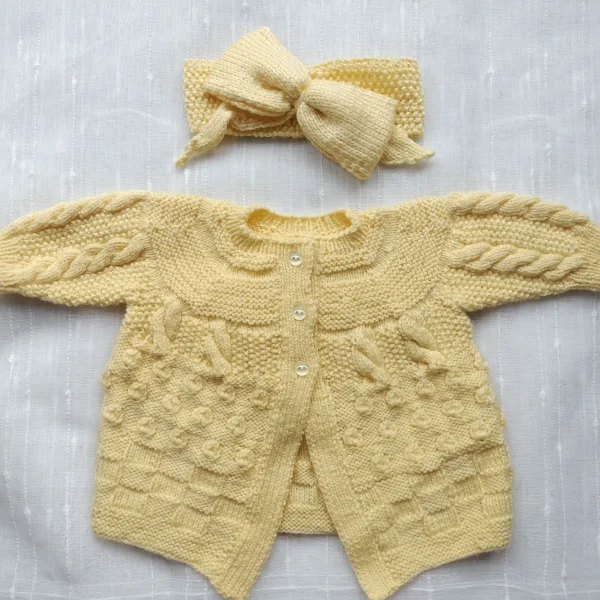 Hand-knitted yellow baby cardigan and bow